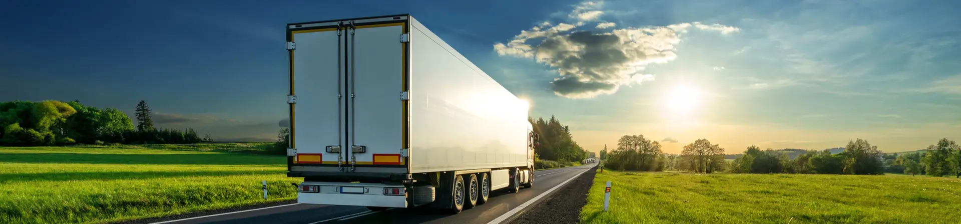 Truck on open road at sunset